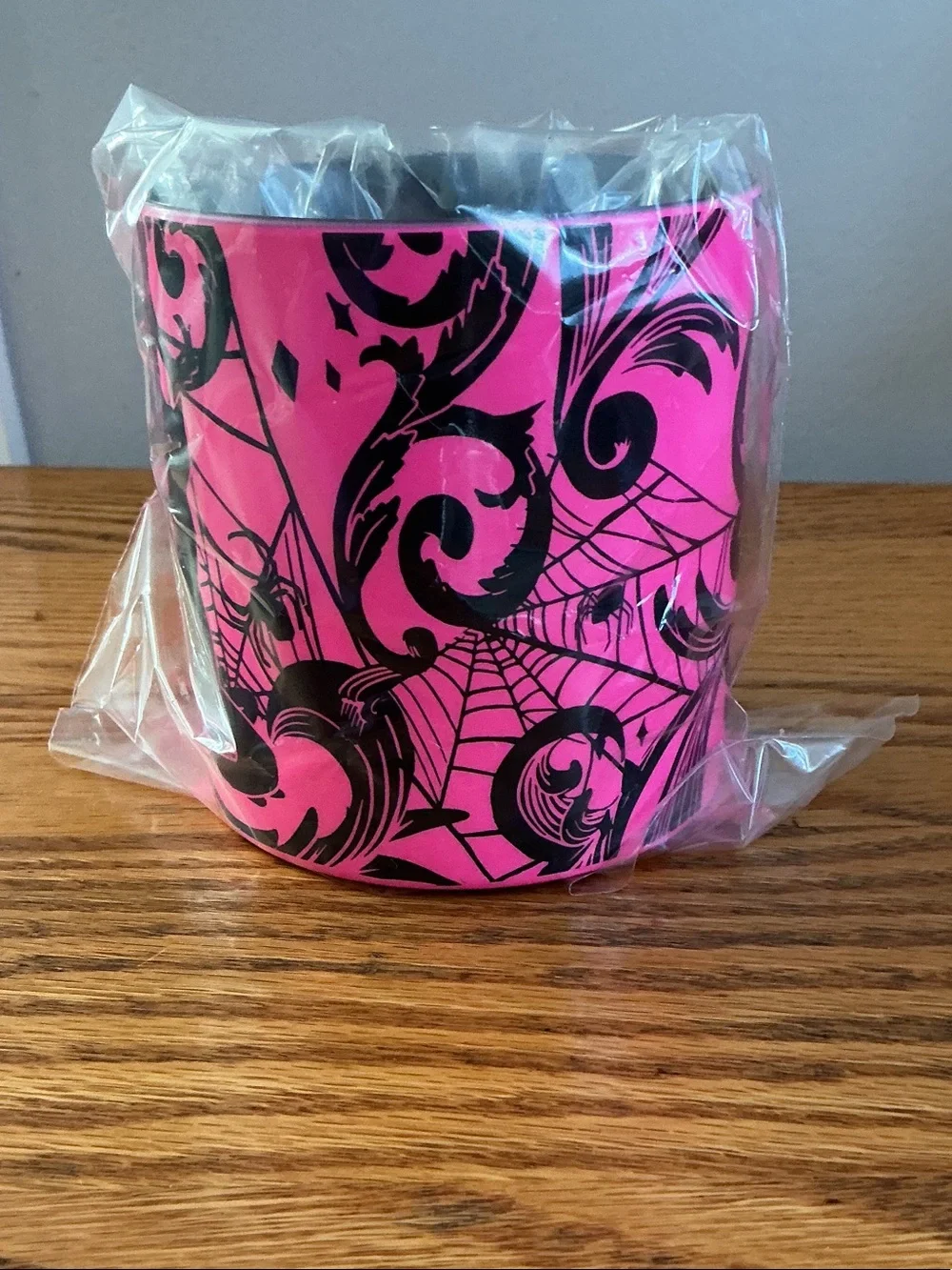 Starbucks Halloween 2021 neon pink coffee mug features a bold black cat-spider.
